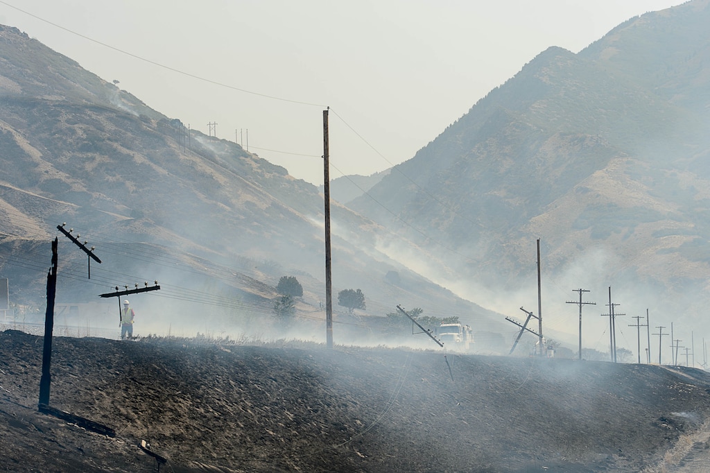 (Trent Nelson | The Salt Lake Tribune)  Power lines along the train tracks after a fire came through at the mouth of Weber Canyon, Tuesday September 5, 2017. The West's electrical grid is facing an increased threat from extreme events like fire.