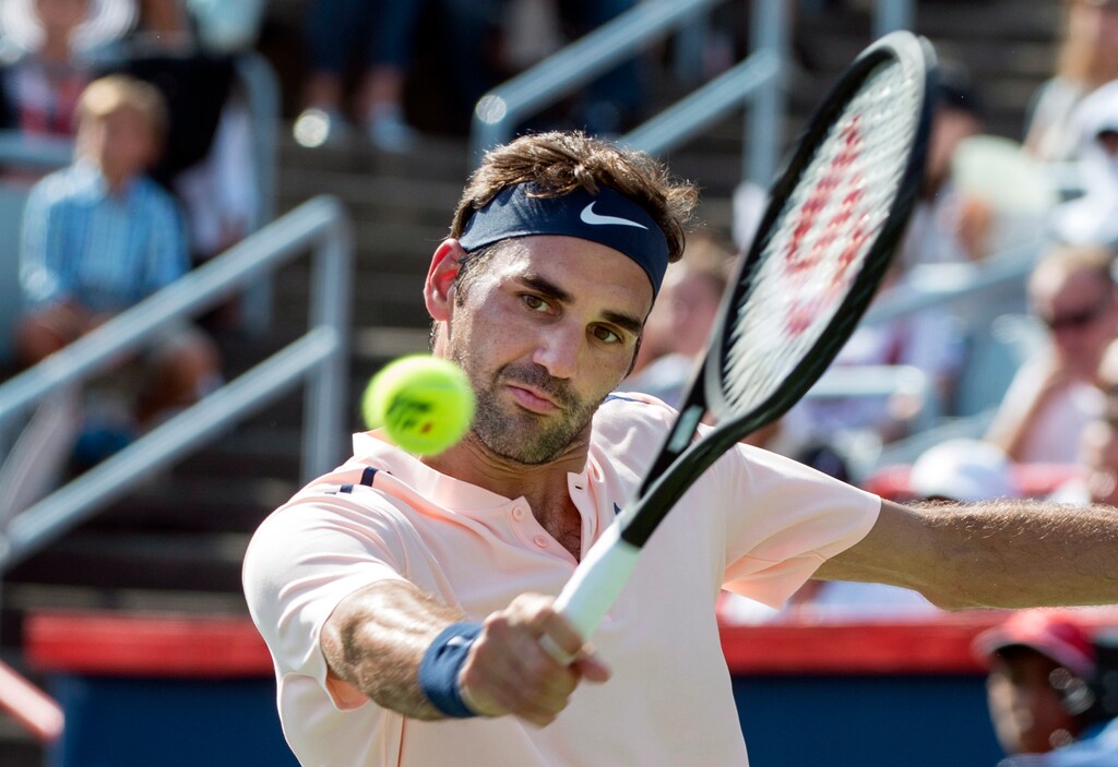 Roger Federer, of Switzerland, returns the ball to Robin Haase, of the Netherlands, during Rogers Cup tennis action in Montreal on Saturday, Aug. 12, 2017. (Paul Chiasson/The Canadian Press via AP)