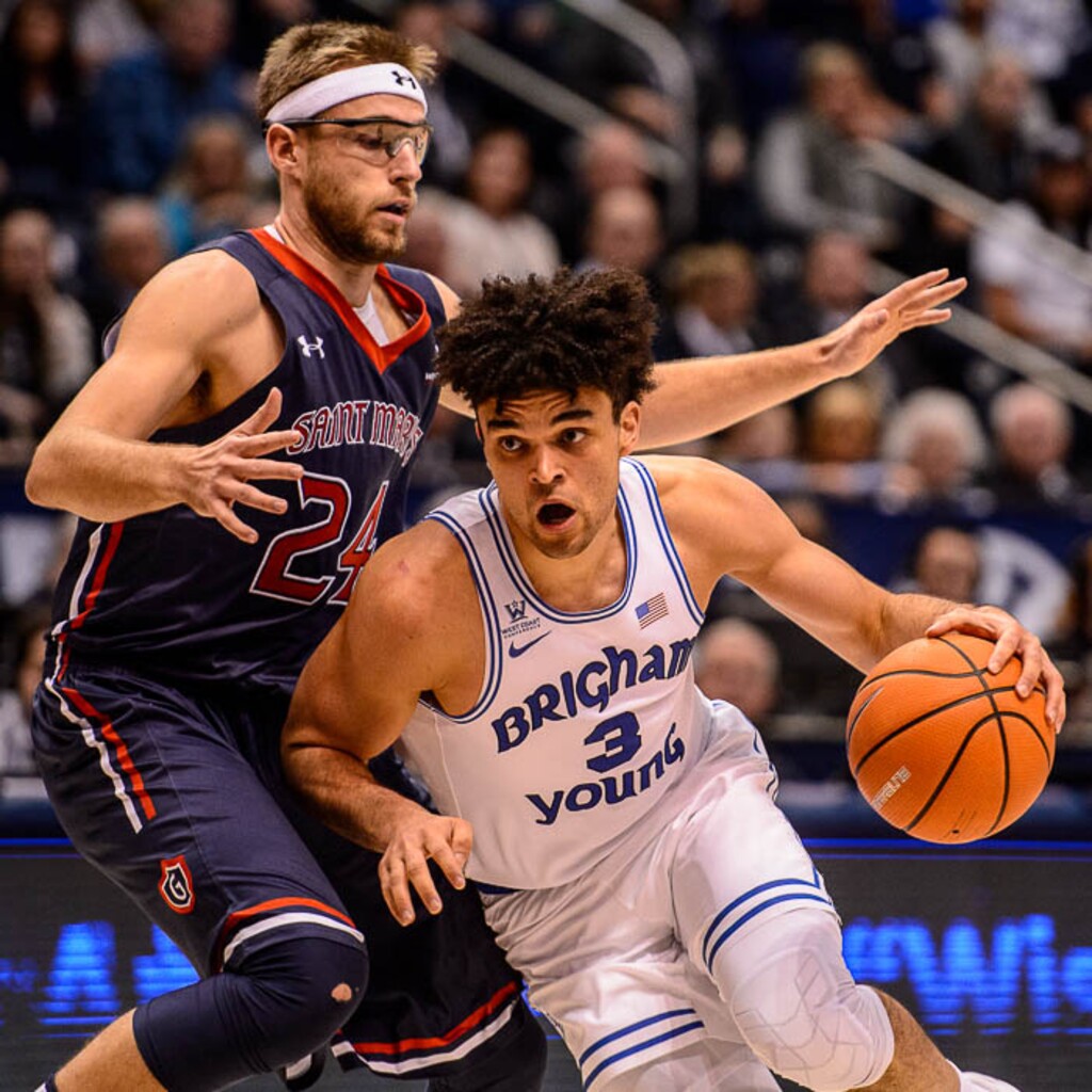 (Trent Nelson | The Salt Lake Tribune)   BYU guard Elijah Bryant (3) drives past St. Mary's Gaels forward Calvin Hermanson (24) as BYU hosts the St. Mary's Gaels, NCAA basketball in Provo, Saturday December 30, 2017.