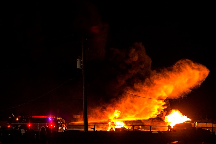 (Chris Detrick  |  The Salt Lake Tribune)  Firefighters attempt to put out a burning semitrailer that was hauling thousands of gallons of fuel on Interstate-15 in Midvale Thursday, January 18, 2018.   Lt. Todd Royce of the Utah Highway Patrol said the truck was southbound on the interstate at 7500 South at 7:20 p.m. when a tire caught fire, sending flames toward the tanks.