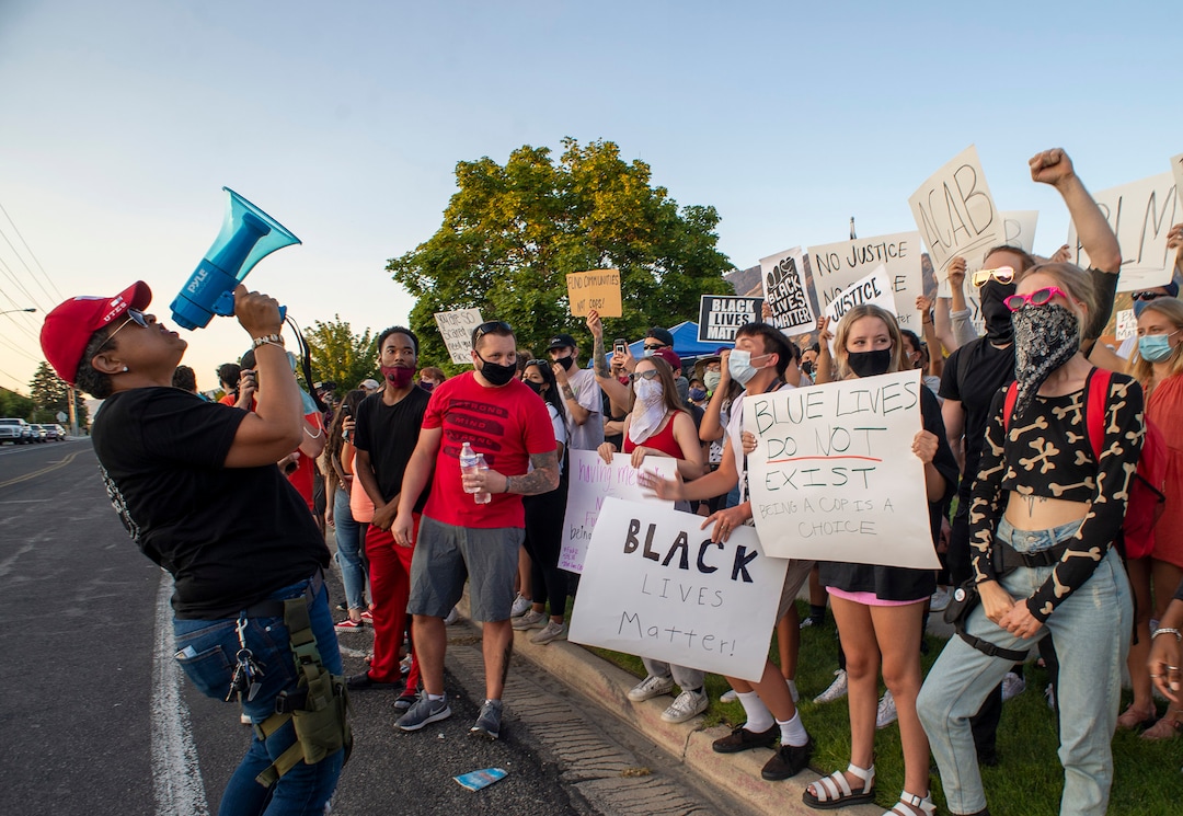 (Rick Egan  |  The Salt Lake Tribune)   Lex Scott from Black Lives Matter Utah leads chant as counter protesters stand across the street at Cottonwood Heights police station on Monday, Aug. 3, 2020.