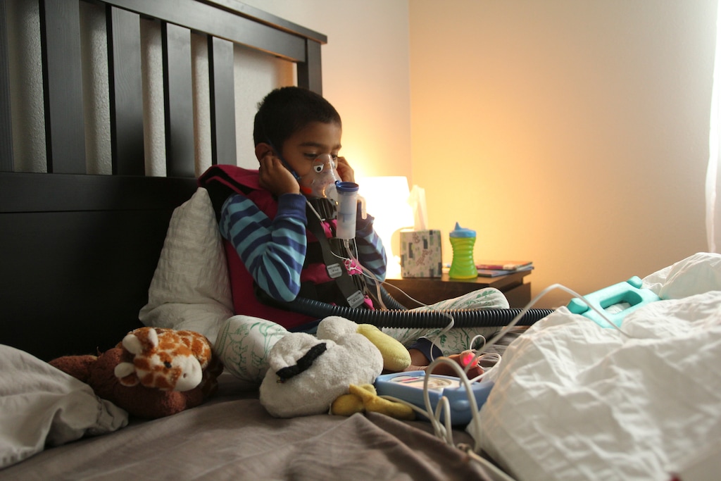 (Alison Chandra via The New York Times) In an undated image provided by Alison Chandra, Alison Chandra's son, Ethan, who has heterotaxy syndrome, which makes it difficult for his lungs to clear mucus, wearing his medical vest and using a nebulizer. When Ethan tested positive for the coronavirus, his mother vented her frustration on social media, blaming low vaccination rates in Utah.