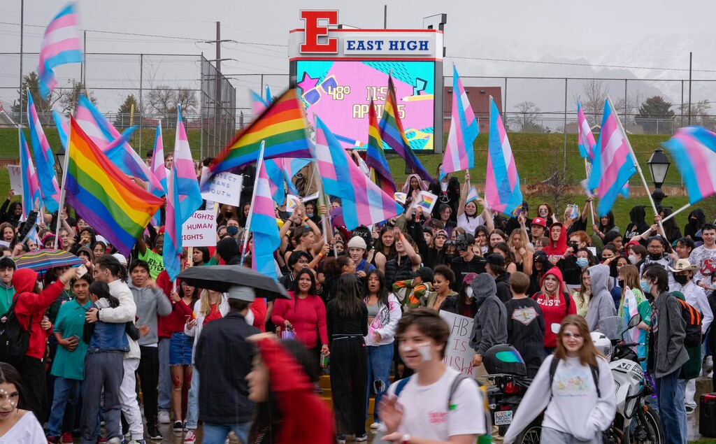 (Francisco Kjolseth | The Salt Lake Tribune) As the rain fell, East High school students gather outside of school for walkout on Friday, April 15, 2022, to protest HB11, which bans transgender girls from participating in female school sports.
