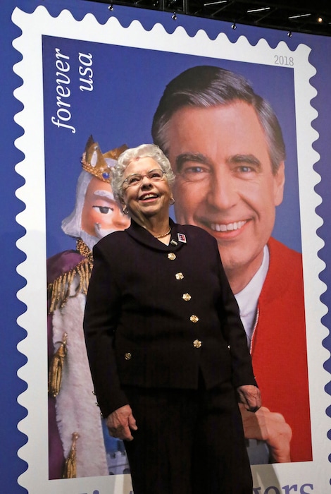 (AP Photo/Gene J. Puskar) Joanne Rogers, wife of the late Fred Rogers, stands in front of a giant Mister Rogers Forever Stamp following the first-day-of-issue dedication in WQED's Fred Rogers Studio in Pittsburgh, Friday, March 23, 2018.