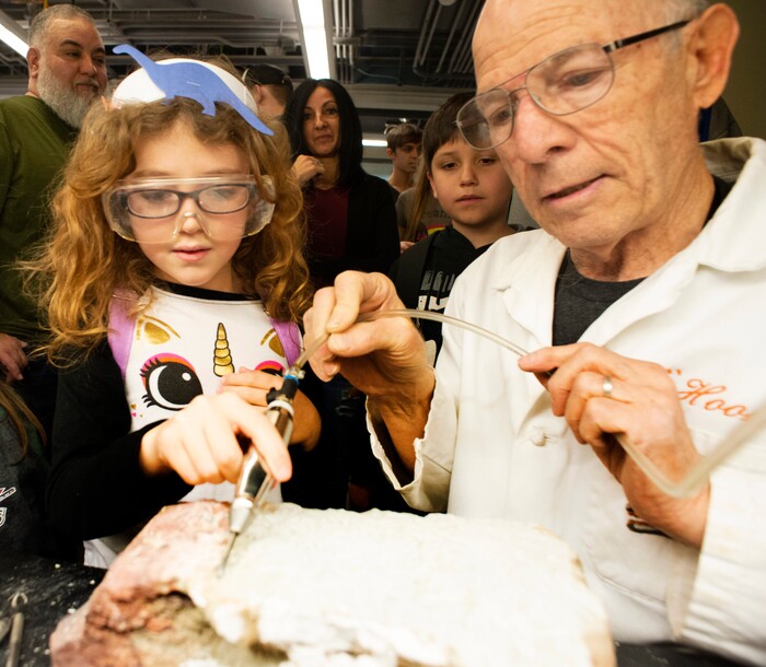 (Rick Egan | The Salt Lake Tribune) Lew Ershler shows Ariel Coleman the tools they use in the lab, during the Utah Natural History Museum DinoFest. The Museum is celebrating it's 50th anniversary in Utah to day and tomorrow, Saturday, Jan. 25, 2020.