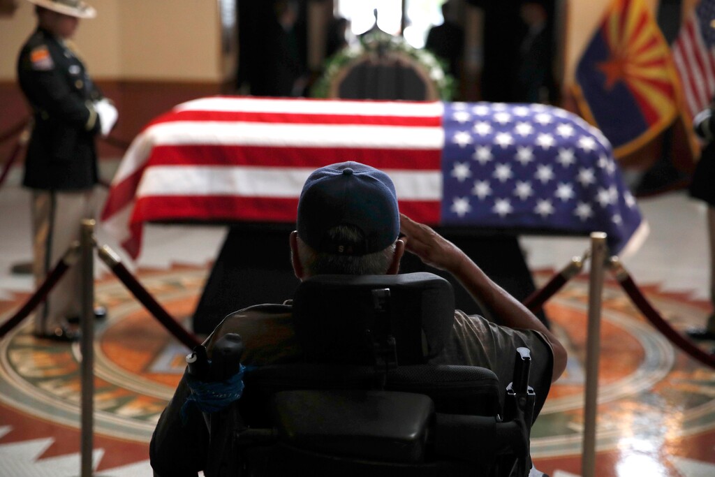 A former serviceman salutes near the casket during a memorial service for Sen. John McCain, R-Ariz. at the Arizona Capitol on Wednesday, Aug. 29, 2018, in Phoenix. (AP Photo/Jae C. Hong, Pool)