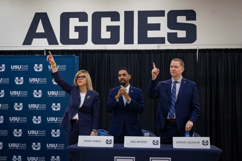 (Rick Egan | The Salt Lake Tribune)  Diana Sabau,Vice President & Athletics Director leads the coaches in   the Aggie fight song, during a news conference introducing Wesley Brooks and Jerrod Calhoun as the AggiesÕ new  womenÕs and menÕs basketball head coaches, at Utah State University, in Logan, on Tuesday, April 2, 2024.