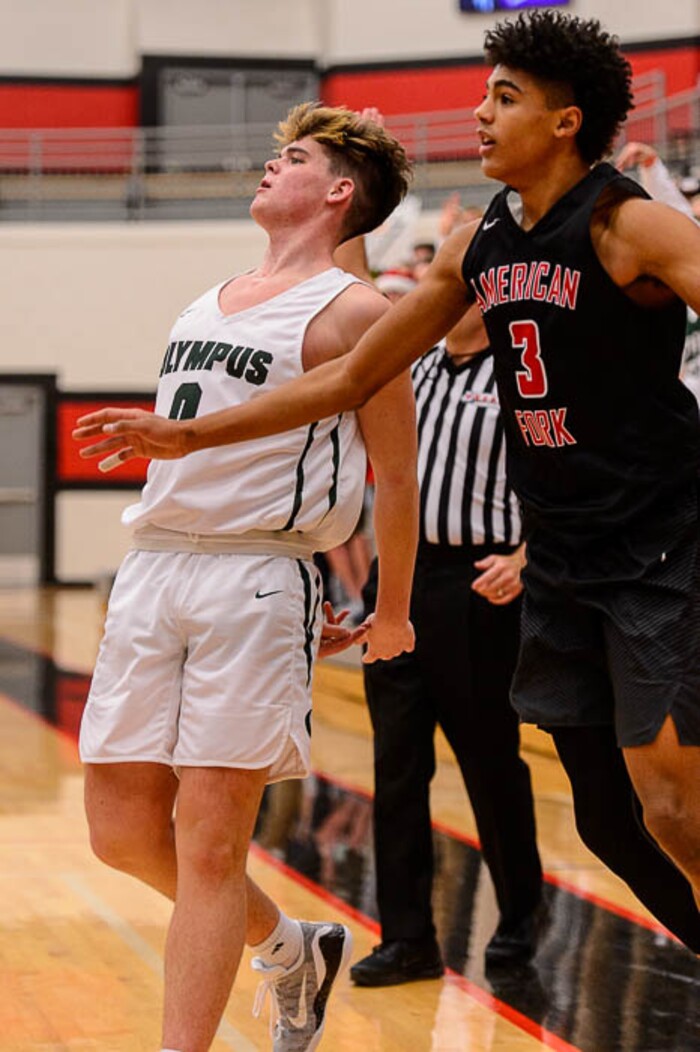(Trent Nelson | The Salt Lake Tribune)  Olympus's Caden Kuhn watches a three-pointer go in as American Fork hosts Olympus in the Utah Elite Eight tournament, Saturday December 9, 2017.