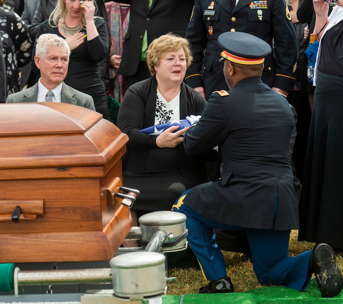 (Rick Egan  |  The Salt Lake Tribune)     A member of the Honor Guard presents Mary Ann Turner, the daughter of 2nd Lt. Lynn W. Hadfield, the flag from her father's casket during the graveside service for 2nd Lt. Lynn W. Hadfield, who was killed during the Second World War, at Veterans Memorial Park, in Bluffdale. Thursday, March 21, 2019.


