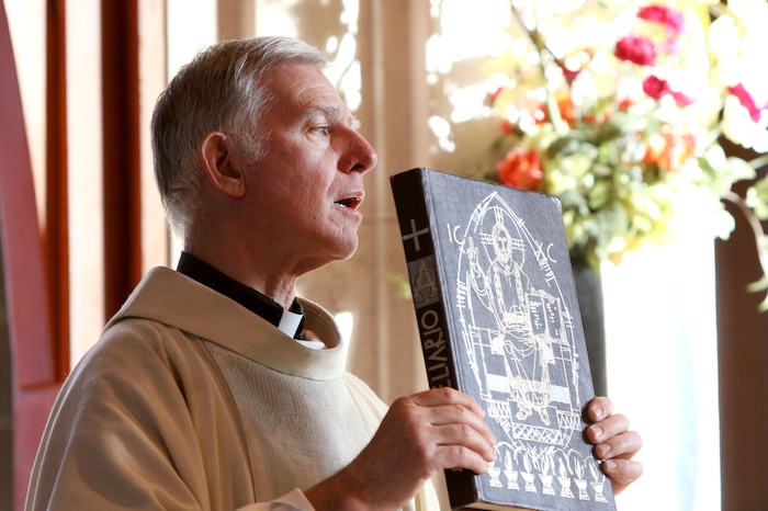 Erik Daenitz  |  Special to the Tribune

Father Bob Bussen presents the gospel at St. Mary's Parish in Park City on Sunday, May 16, 2010. Bussen will leave the church after 16 years of service.