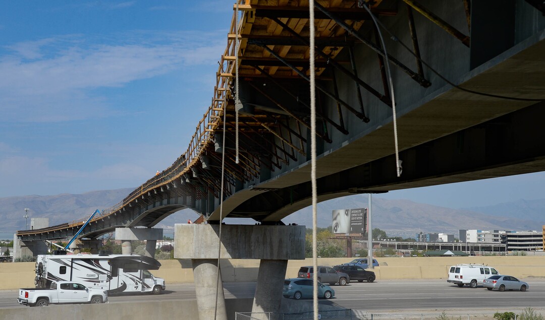 (Francisco Kjolseth  |  The Salt Lake Tribune) UDOT gives a tour of the state’s new longest pedestrian bridge on Thursday, August 20, 2020, connecting Utah Valley University in Orem to student housing and the community on the West side of I-15. Crews are finishing up an extensive hydronic heating system that will pump warm water to keep the bridge clear of snow in the winters, as it gets ready to pour concrete for the walking surface. UDOT will close I-15 in both directions this weekend for work on the nearly 1,000 foot bridge that is 15 feet wide to accommodate pedestrians, cyclists and scooters. Elevators and stairs with small ramps to push up bicycles will be on each side of the bridge.