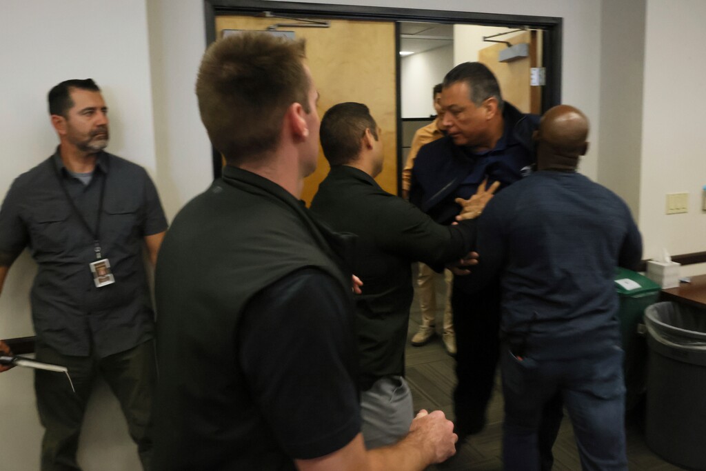 U.S. Sen. Alex Padilla, D-Calif., is pushed out of the room as Homeland Security Secretary Kristi Noem holds a news conference regarding the recent protests in Los Angeles on Thursday, June 12, 2025. (AP Photo/Etienne Laurent)
