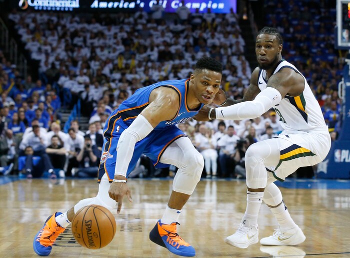 Oklahoma City Thunder guard Russell Westbrook, left, reaches for the ball in front of Utah Jazz forward Jae Crowder during the first half of Game 5 of an NBA basketball first-round playoff series in Oklahoma City, Wednesday, April 25, 2018. (AP Photo/Sue Ogrocki)