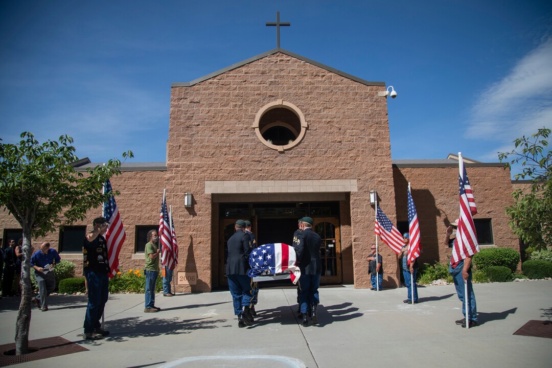 (Ben Dorger | Standard-Examiner via AP) Military personnel carry the remains of Army Sgt. 1st Class Elliott Robbins into St. James Catholic Church in Ogden, Utah on Thursday, July 18, 2019. Robbins died in a non-combat incident on June 30 while serving in Afghanistan.