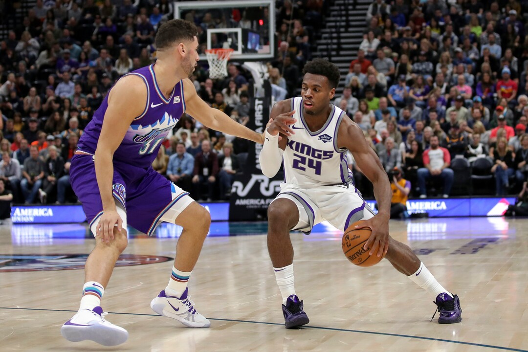Sacramento Kings guard Buddy Hield (24) keeps the ball away from Utah Jazz forward Georges Niang (31) during the second quarter of an NBA basketball game, Saturday, Oct. 26, 2019, in Salt Lake City. (AP Photo/Chris Nicoll)