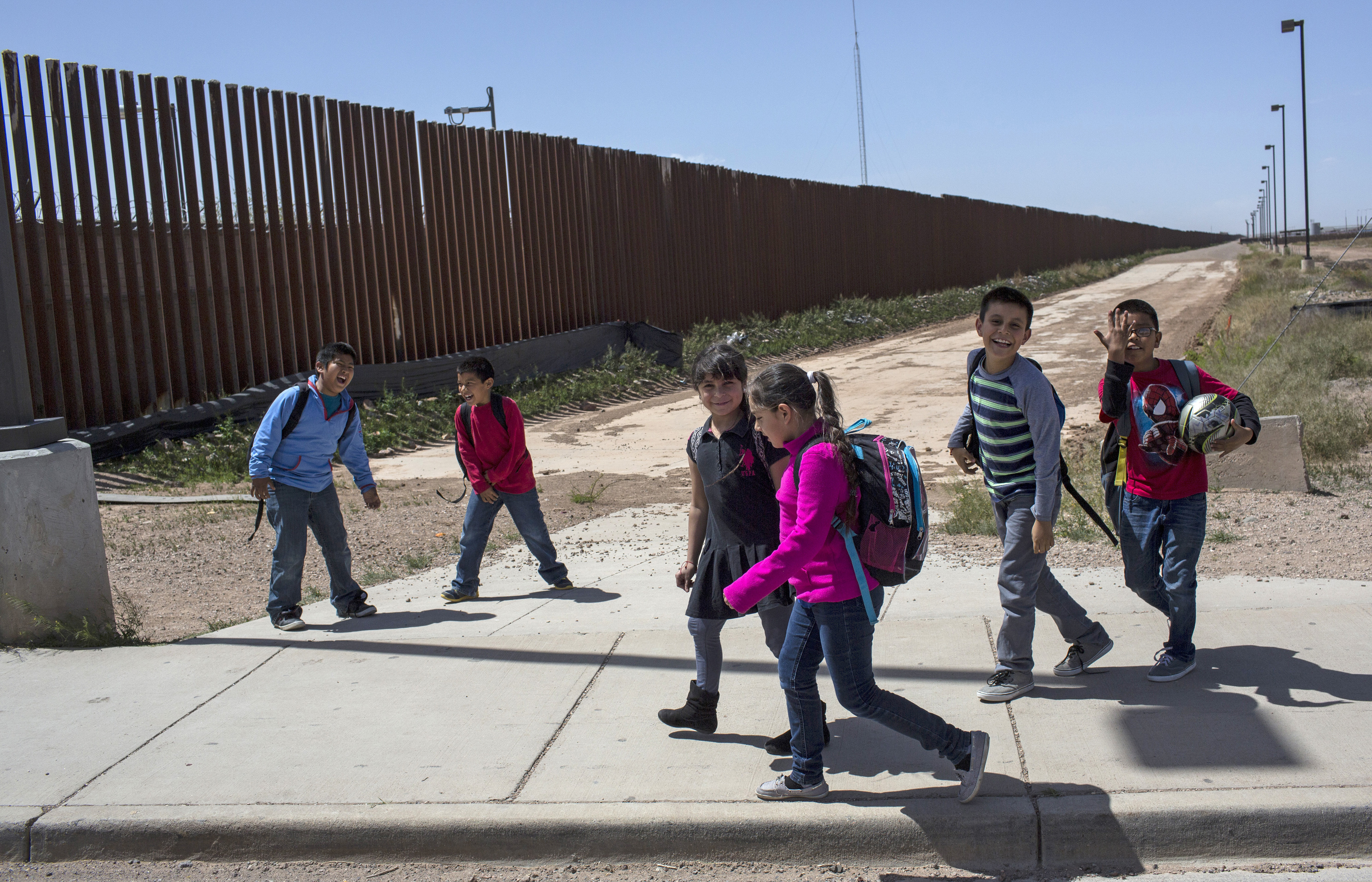 (Rodrigo Abd | The Associated Press) In this March 31, 2017 file photo, Columbus Elementary School students walk towards the U.S. port of entry on the border with Puerto Palomas, Mexico, after attending school in Columbus, New Mexico. President Donald Trump is not giving up on his demands for $5.7 billion to build a wall along the U.S.-Mexico border, saying a physical barrier is central to any strategy for addressing the security and humanitarian crisis at the southern border. Democrats argue that funding the construction of a steel barrier along roughly 234 miles will not solve the problems.