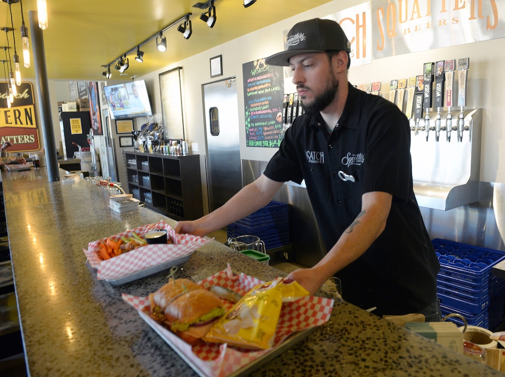 (Al Hartmann | Salt Lake Tribune file photo) Bartender Matt Green serves up a turkey guac sandwich at West Side Tavern in Salt Lake City shortly after its opening in 2017. West Side Tavern was awarded a seasonal bar license at the Utah Department of Alcoholic Beverage Services commission meeting on Nov. 29, 2022.