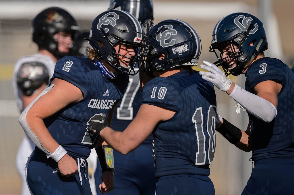 (Trent Nelson | The Salt Lake Tribune) Corner Canyon's Jaxson Dart celebrates with Austin Bell (10) and Cody Hagen (3) at the end of the 6A state football championship game against Lone Peak at Cedar Valley High School in Eagle Mountain on Friday, Nov. 20, 2020.