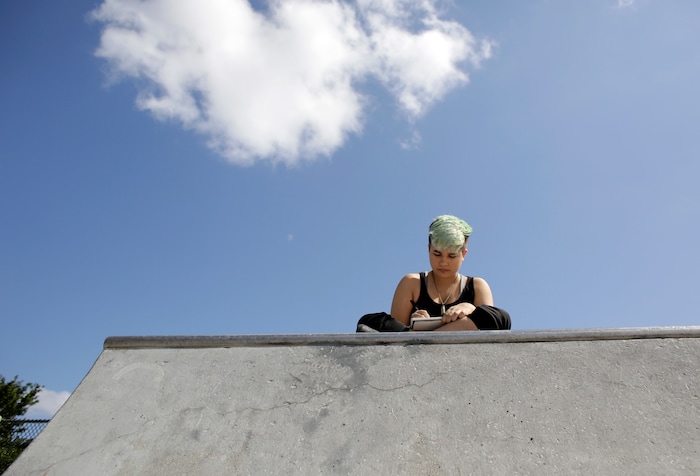 (Lynne Sladky | The Associated Press) In this Thursday, April 28, 2016 photo, Theo Ramos, 14, draws in his sketch book at his neighborhood park in Homestead, Fla. Born a girl, he felt more like a boy. He wanted to be called Theo instead of the name he was given at birth _ he wrote a detailed letter to teachers, explaining which pronouns he preferred and citing school policy on LGBTQ inclusion.
