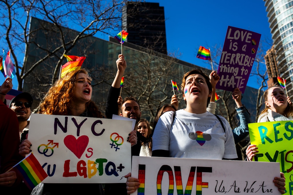 (Demetrius Freeman | Special to The Tribune) Maddie Hall, 25, left, and Sarah Morris chant with current and former members of The Church of Jesus Christ of Latter-day Saints, the LGBTQ+ community, and supporters demonstrate at Lincoln Square across from the Latter-day Saints temple in Manhattan on Saturday, March 7, 2020. BYU reinstated policies in its student handbook that prohibit "homosexual behavior."