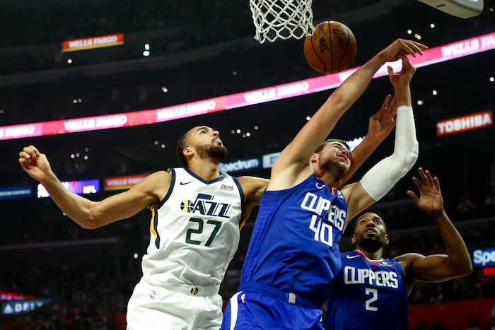 Utah Jazz's Rudy Gobert (27) fights for a rebound against Los Angeles Clippers' Ivica Zubac (40) and Kawhi Leonard (2) during the first half of an NBA basketball game Sunday, Nov. 3, 2019, in Los Angeles. (AP Photo/Ringo H.W. Chiu)