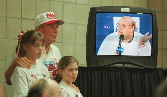 (Steve Griffin  |  Tribune file photo)  Jon Huntsman Sr. with his arms around Rick Majerus's nieces, Tory and Kelly Dowd, listens to the coach during post game interviews after the Utes defeated North Carolina in the 1998 Final Four in San Antonio, Texas.