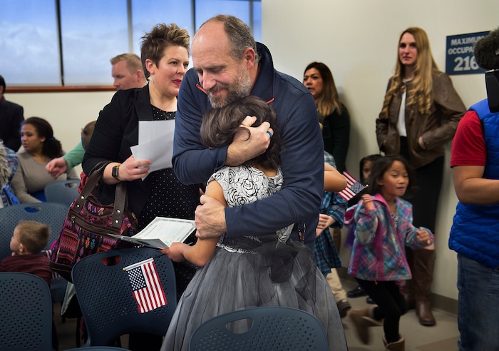 (Scott Sommerdorf   |  The Salt Lake Tribune)   Jeff Murray, father of Lachlan Murray, hugs his daughter after she became a U.S. citizen during a ceremony in recognition of children who have obtained citizenship through their parents, Thursday, December 28, 2017. Some were adopted by U.S. citizen parents; others derived citizenship when their immigrant parents became naturalized citizens.