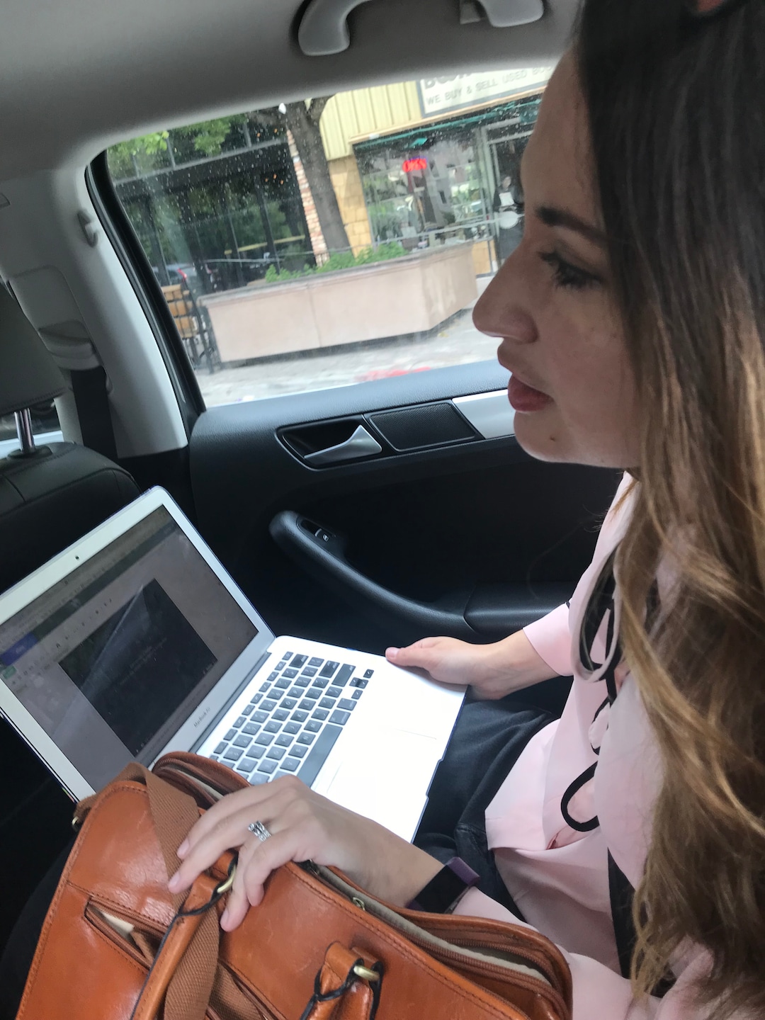 (Kolbie Peterson | The Salt Lake Tribune) Digital News Editor Rachel Piper tries to tell her Lyft driver what route to take to avoid going in a giant square around the city.
