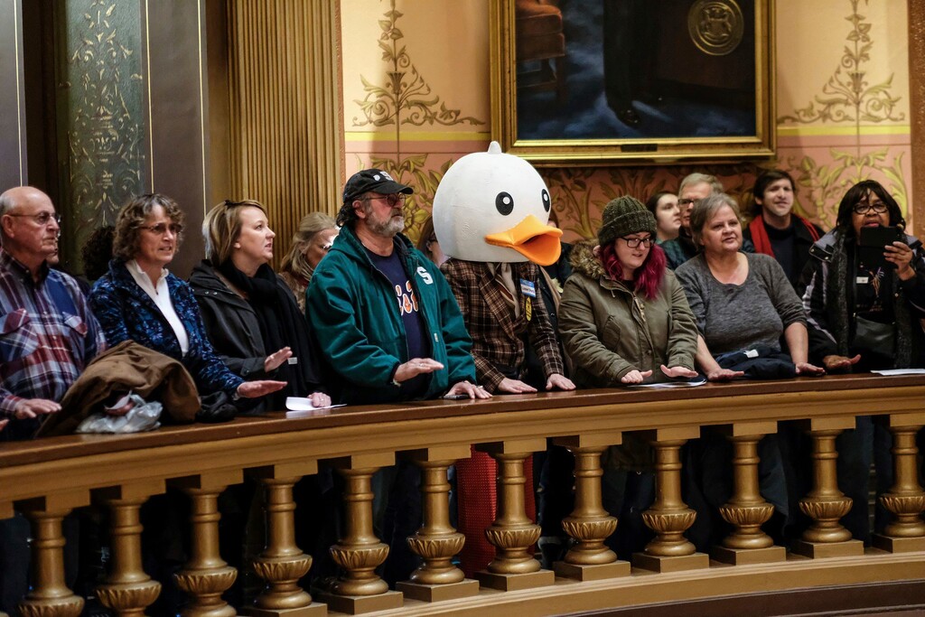 In this Tuesday, Dec. 4, 2018, photo, people gather to protest at the Capitol Rotunda in Lansing, Mich. The incoming Democratic governor of Wisconsin said Wednesday that he plans to make a personal appeal to his defeated rival, Gov. Scott Walker, to veto far-reaching GOP legislation that would restrict the new administration's powers. (Robert Killips/Lansing State Journal via AP)