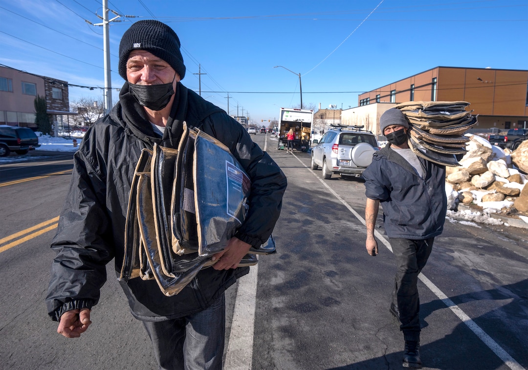 (Rick Egan | The Salt Lake Tribune) JJ and Georgia, volunteers with Black Lives for Humanity, distribute wool blankets donated by the Sikh community to people in camps in Salt Lake City to help the unsheltered stay warm Thursday, Dec. 23, 2021.