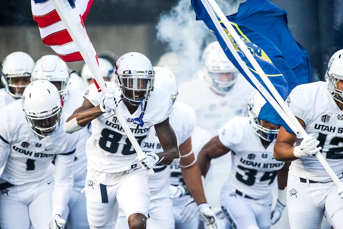 (Chris Detrick  |  The Salt Lake Tribune)  Utah State Aggies wide receiver Braelon Roberts (88) and his teammates run onto the field during the game at Merlin Olsen Field at Maverik Stadium Friday, September 29, 2017.