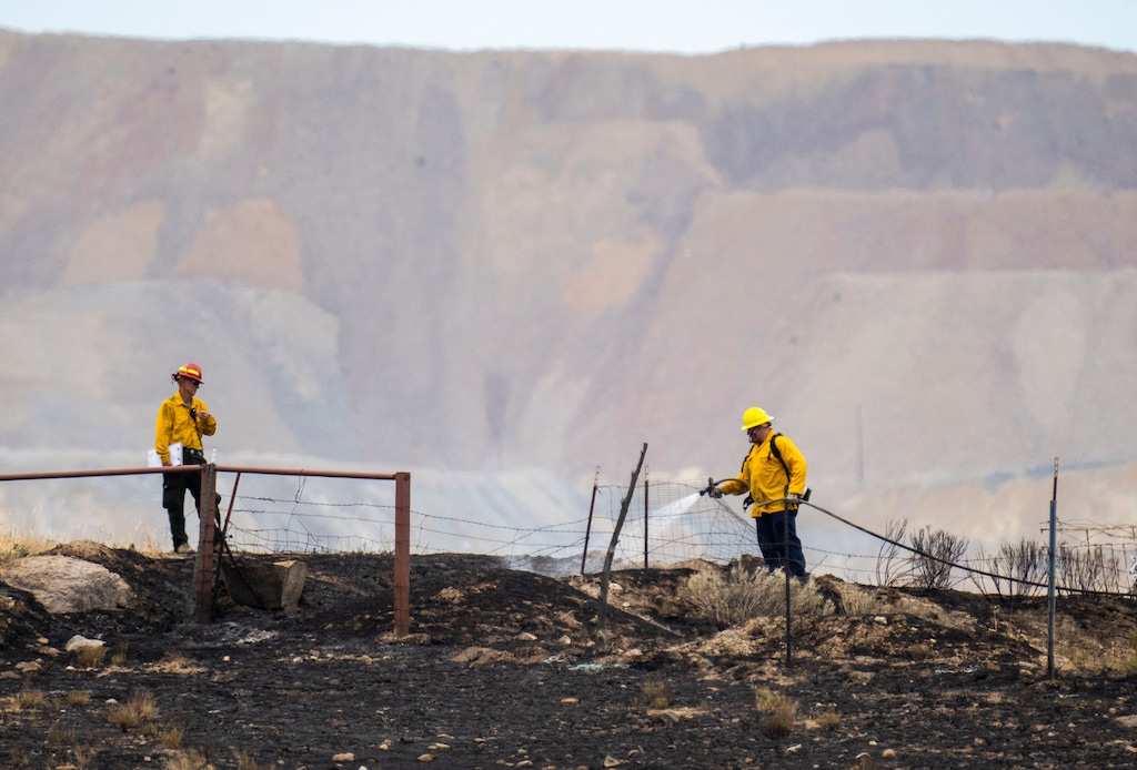 (Rick Egan | The Salt Lake Tribune) Firefighters spray hot spots on a wildfire fire in Herriman, on Friday, July 16, 2021.