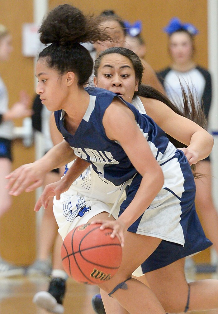 (Leah Hogsten  |  The Salt Lake Tribune) Bingham's Meleane Lokotui (23) fouls Copper Hills' Eleyana Tafisi (03).  Bingham faces Copper Hills in their semifinal game of the 6A High School Girls' Basketball Tournament at SLCC in Taylorsville, Friday, Feb. 23, 2018. 