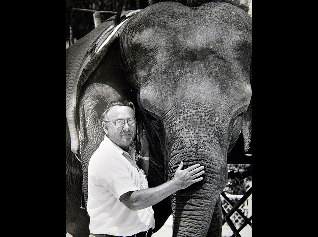 (Lynn Johnson | Tribune file photo) In this 1984 photograph, Hogle Zoo Director Lamar Farnsworth stands next to an elephant. Farnsworth died Oct. 17, 2019, at age 86.