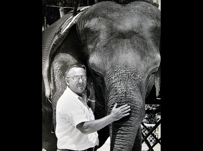 (Lynn Johnson | Tribune file photo) In this 1984 photograph, Hogle Zoo Director Lamar Farnsworth stands next to an elephant. Farnsworth died Oct. 17, 2019, at age 86.