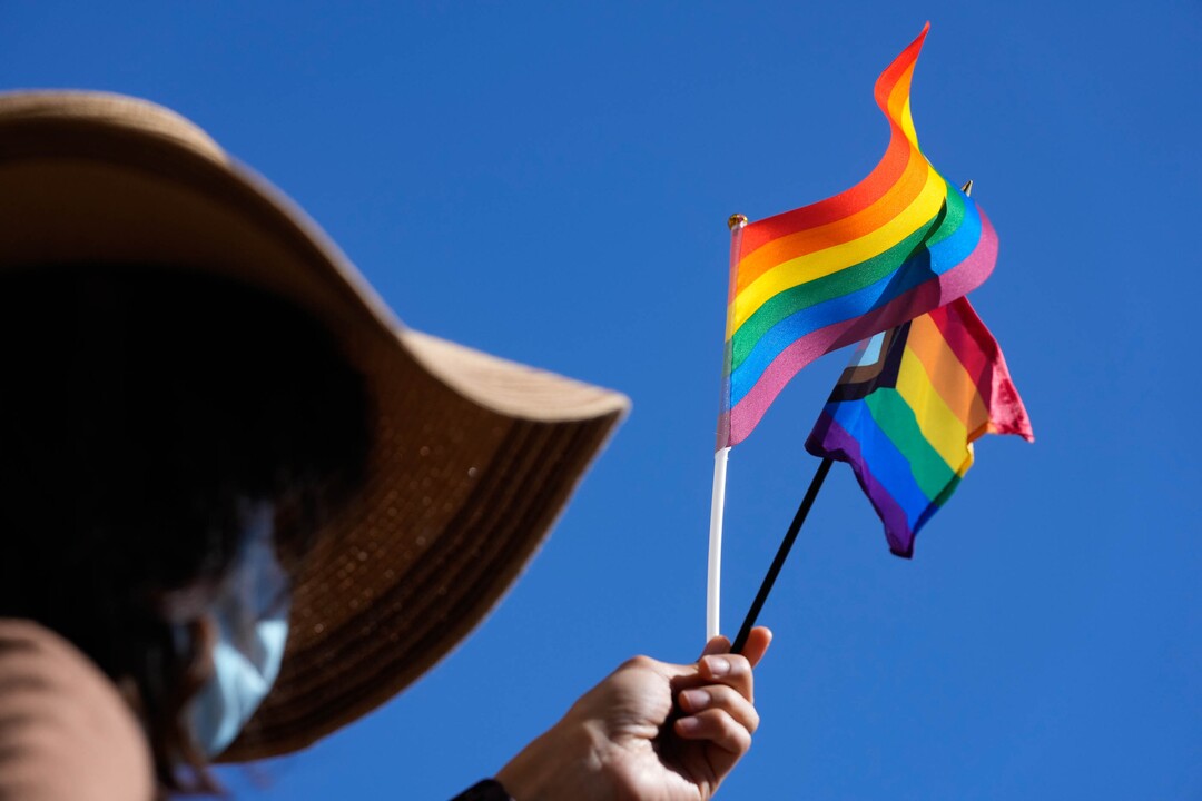 (Francisco Kjolseth | The Salt Lake Tribune) Yvette Gutierrez, a college advisor at West High School waves a pride flag and progress pride flag in support of the school’s students who staged a walkout on Wednesday, April 6, 2022 to protest HB11, which bans transgender girls from participating in female school sports.