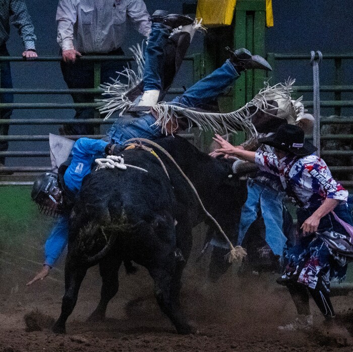 (Rick Egan | The Salt Lake Tribune) 
A bull rider tries to stay on during the bull riding competition in the Panguitch Invitational Rodeo, on Saturday, July 23, 2022.