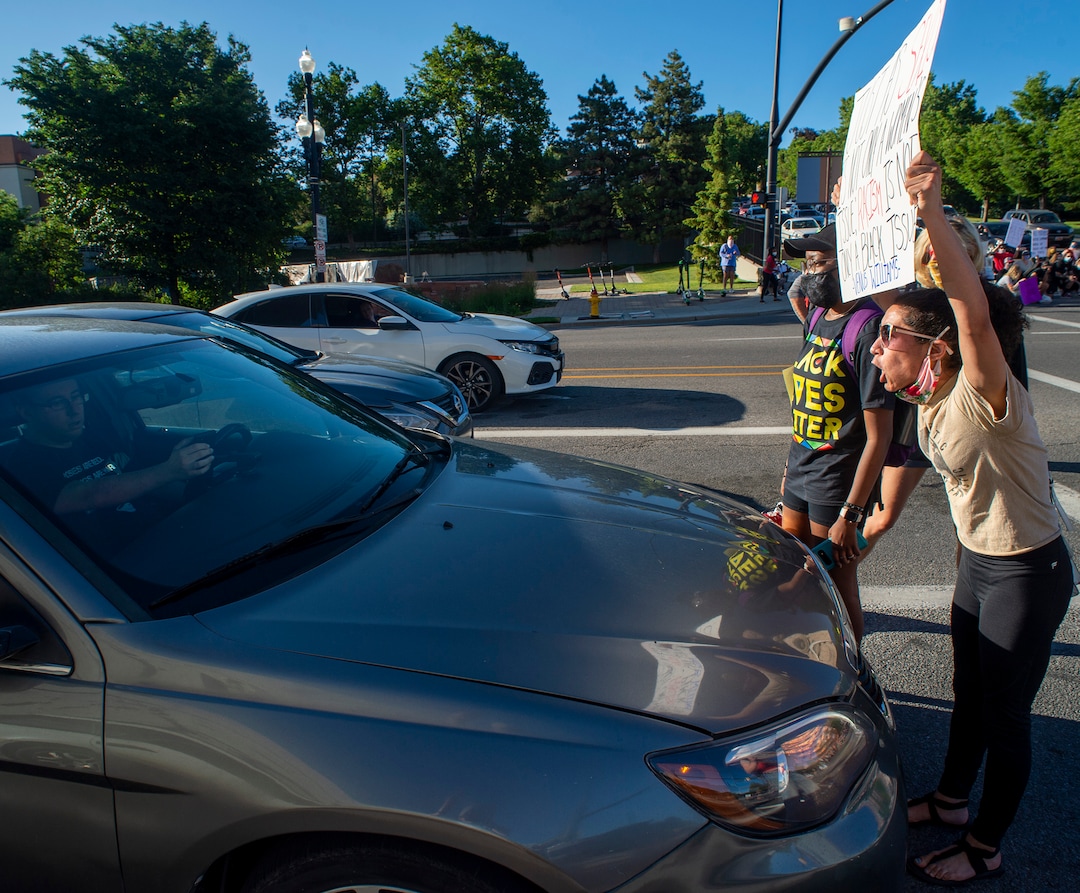 (Rick Egan  |  The Salt Lake Tribune)     A protesters faces off with a motorist, on North Temple and State Street from the State Capitol on Wednesday, June 10, 2020.