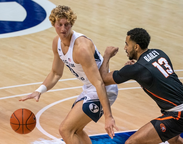 (Rick Egan | The Salt Lake Tribune)  Pacific Tigers forward Jeremiah Bailey (13), , rests his arm on the back of Brigham Young Cougars forward Caleb Lohner (33)in basketball action at the Marriott Center in Provo, on Saturday, Jan. 30, 2021.