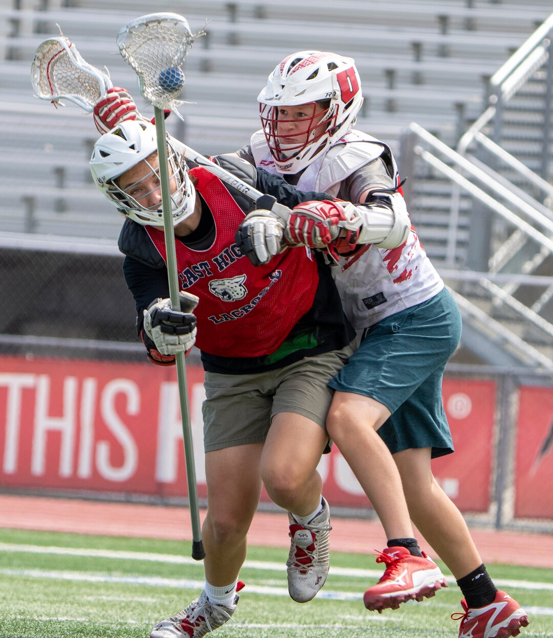 (Rick Egan | The Salt Lake Tribune)  Reilly Pearson-Ortolani (right) collides with a teammate, during East youth lacrosse practice, on Wednesday, June 22, 2022.