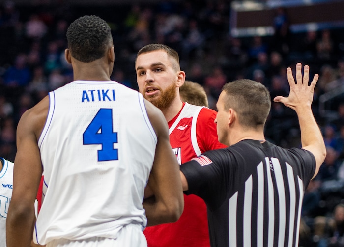 (Rick Egan | The Salt Lake Tribune)  South Dakota Coyotes forward Mihai Carcoana (13) has a few words with Brigham Young Cougars forward Atiki Ally Atiki (4), in basketball action between the Brigham Young Cougars and the South Dakota Coyotes, at Vivint Arena, in Salt Lake City, on Saturday, Dec. 3, 2022.
