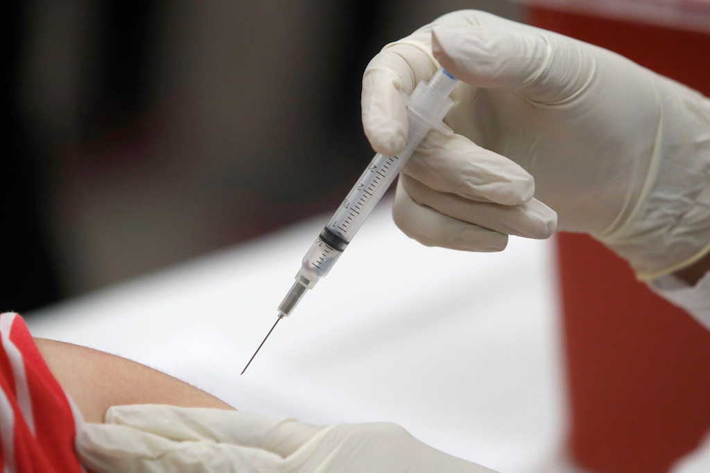 (LM Otero | AP) A patient receives an influenza vaccine in Mesquite, Texas, Thursday, Jan. 23, 2020. New government data suggests more Americans have been getting flu shots in 2020, apparently heeding the advice of health officials fearful of a flu/coronavirus double pandemic.