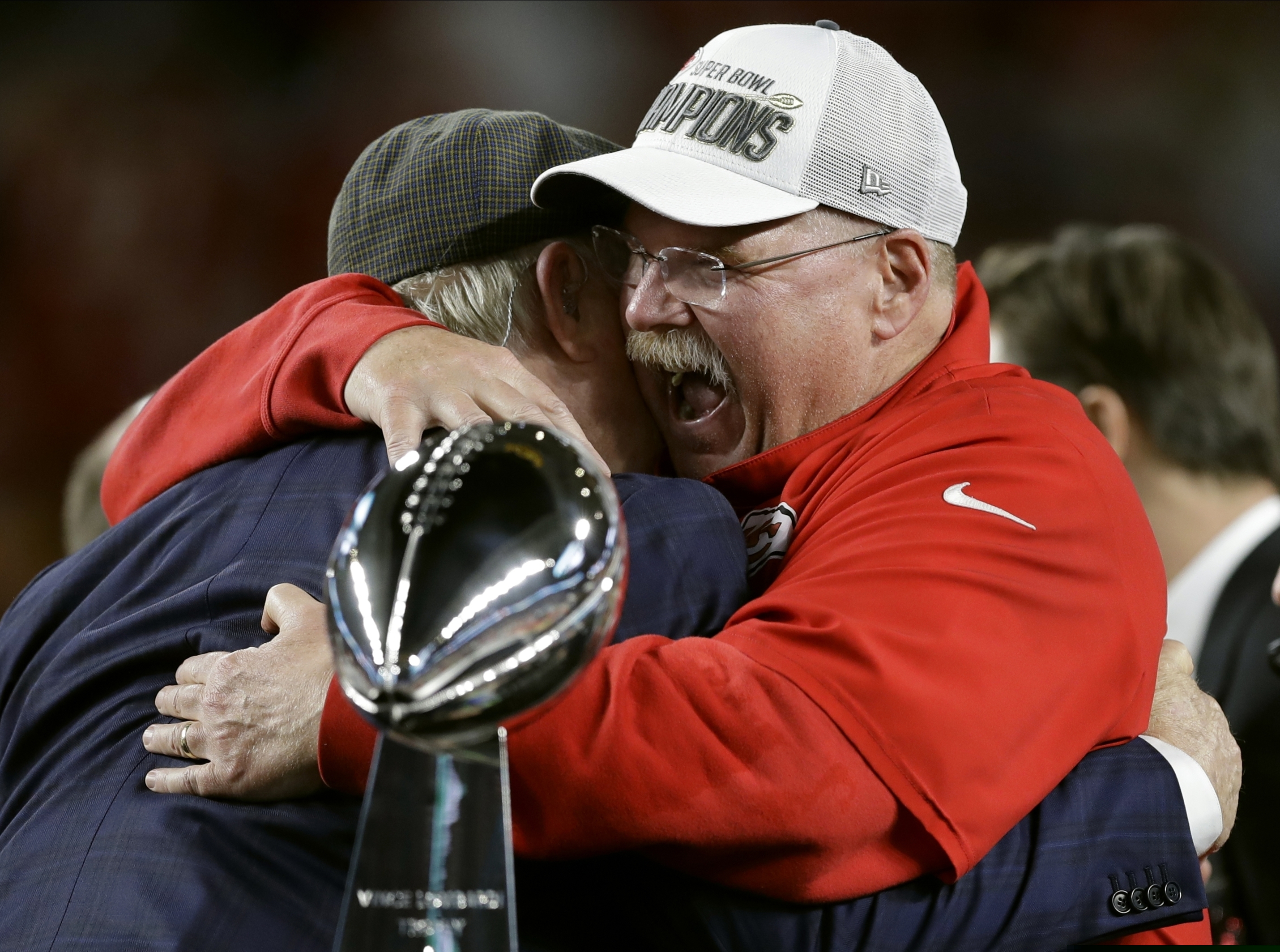 Kansas City Chiefs head coach Andy Reid receives congratulations from broadcaster Terry Bradshaw after defeating the San Francisco 49ers in the NFL Super Bowl 54 football game Sunday, Feb. 2, 2020, in Miami Gardens, Fla. (AP Photo/Chris O'Meara)