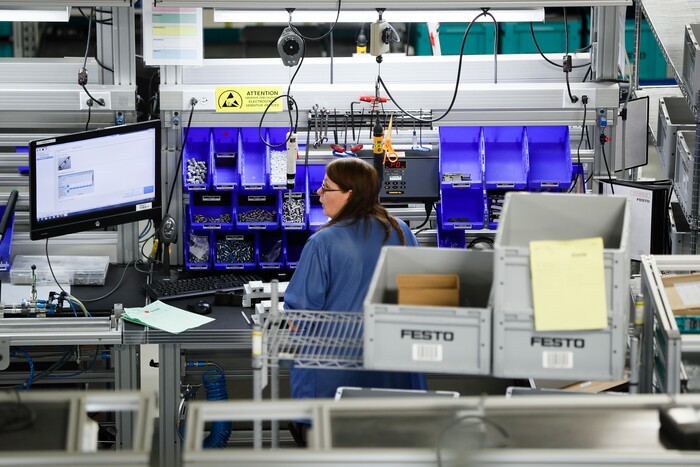 In this Wednesday, May 17, 2017 photo, an employee stands at her workstation at the Festo distribution center in Mason, Ohio. As manufacturing automations grow, specialized technical jobs are forecasted to increase. The need to fill those jobs "will happen very quickly," said Yannick Schilly, vice president for North American business for Germany-based Festo, a global industrial automation company. "Those who are positioning themselves the best to cope with technical evolution will be the winners of tomorrow." (AP Photo/John Minchillo)