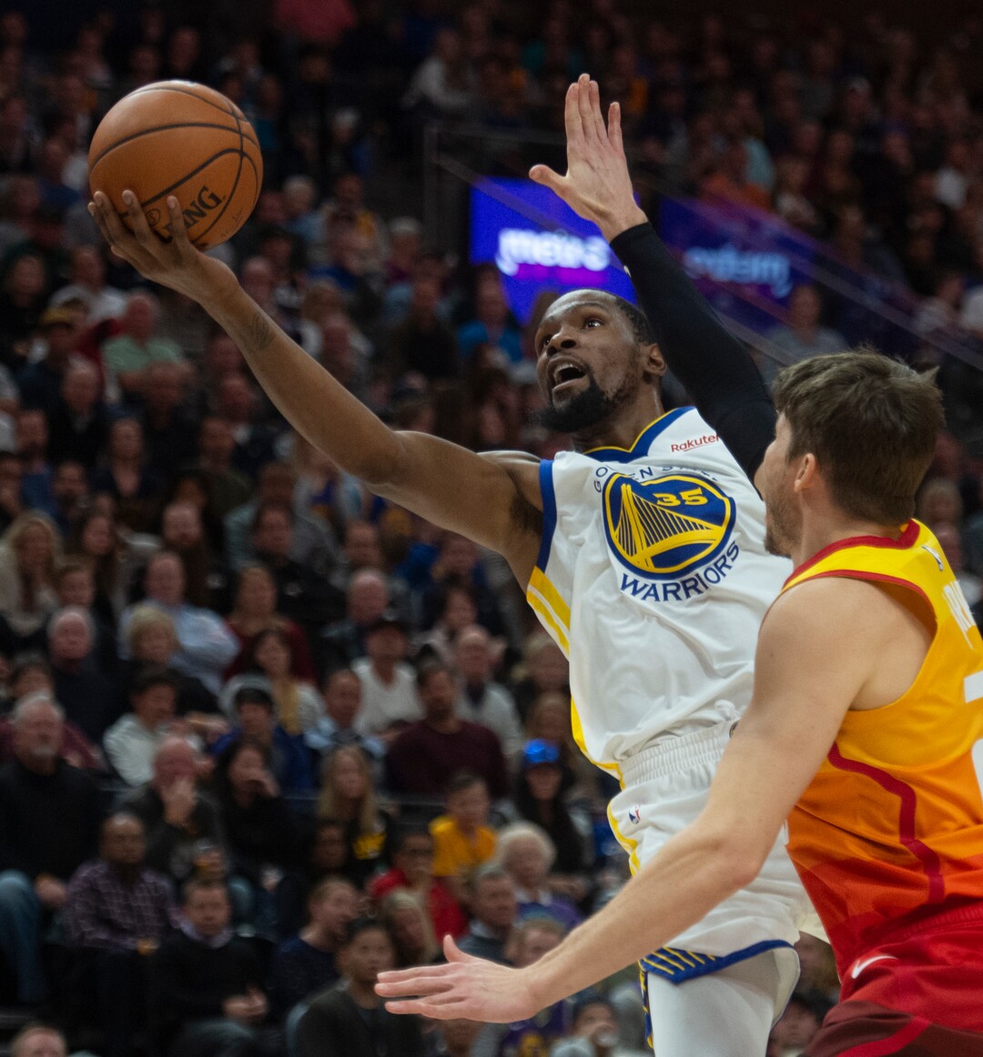 (Rick Egan  |  The Salt Lake Tribune)    Golden State Warriors forward Kevin Durant (35) goes in for a shot as Utah Jazz guard Kyle Korver (26) defends, in NBA action between Utah Jazz and Golden State Warriors, in Salt Lake City, Wednesday, Dec. 19, 2018.
