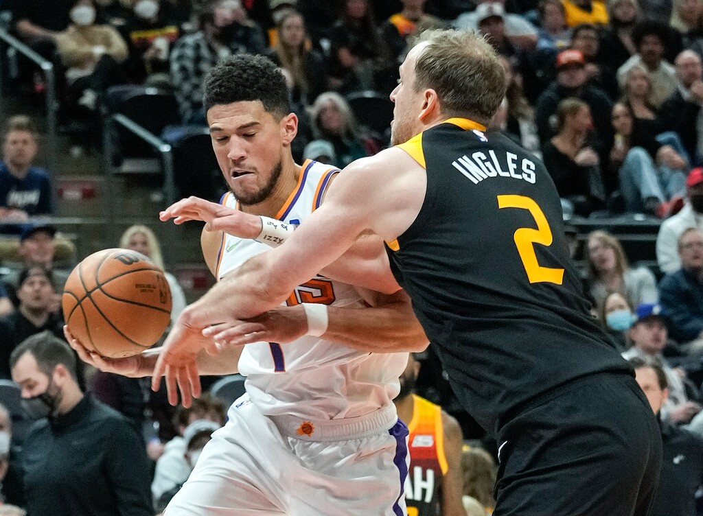 (Leah Hogsten | The Salt Lake Tribune) Utah Jazz guard Joe Ingles (2) pressures Phoenix Suns guard Devin Booker (1) as the Utah Jazz host the Phoenix Suns at Vivint Arena, Jan. 26, 2022. Booker scored 43 points and 12 rebounds. 