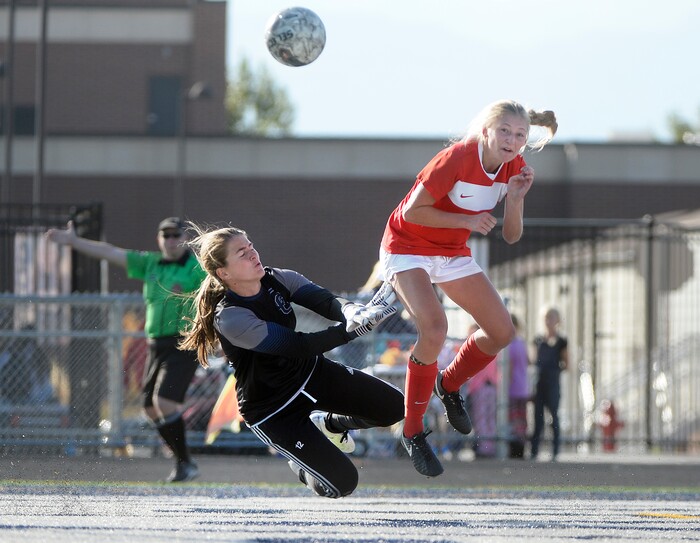 (Scott Sommerdorf   |  The Salt Lake Tribune)   East forward Emily Jensen heads the ball past Corner Canyon goalkeeper Allison Stanley during first half play. East beat Corner Canyon 4-1 in a Class 5A girls' soccer state quarterfinal, Thursday, October 12, 2017. 