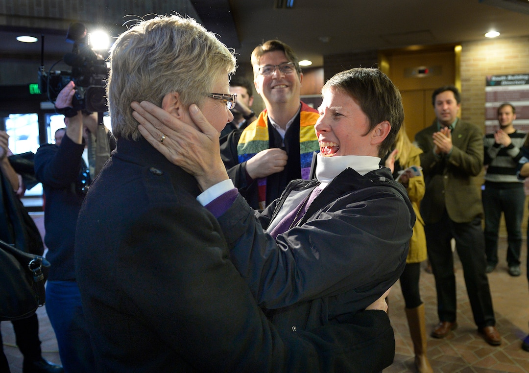 Scott Sommerdorf   |  The Salt Lake TribuneLaurie Wood, left, and Kody Partridge, right react after being told  that they are officially married by the Rev. Curtis L. Price in the lobby of the Salt Lake County offices, Friday December 20, 2013.