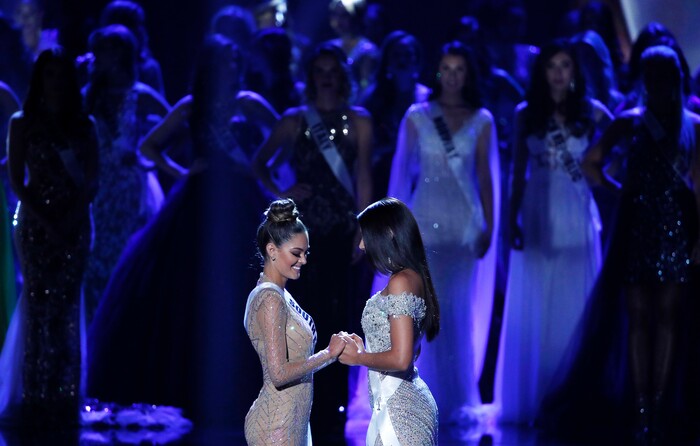 (John Locher | The Associated Press) Miss South Africa Demi-Leigh Nel-Peters, left, and Miss Colombia Laura Gonzalez hold hands before they announce the winner at the Miss Universe pageant Sunday, Nov. 26, 2017, in Las Vegas.