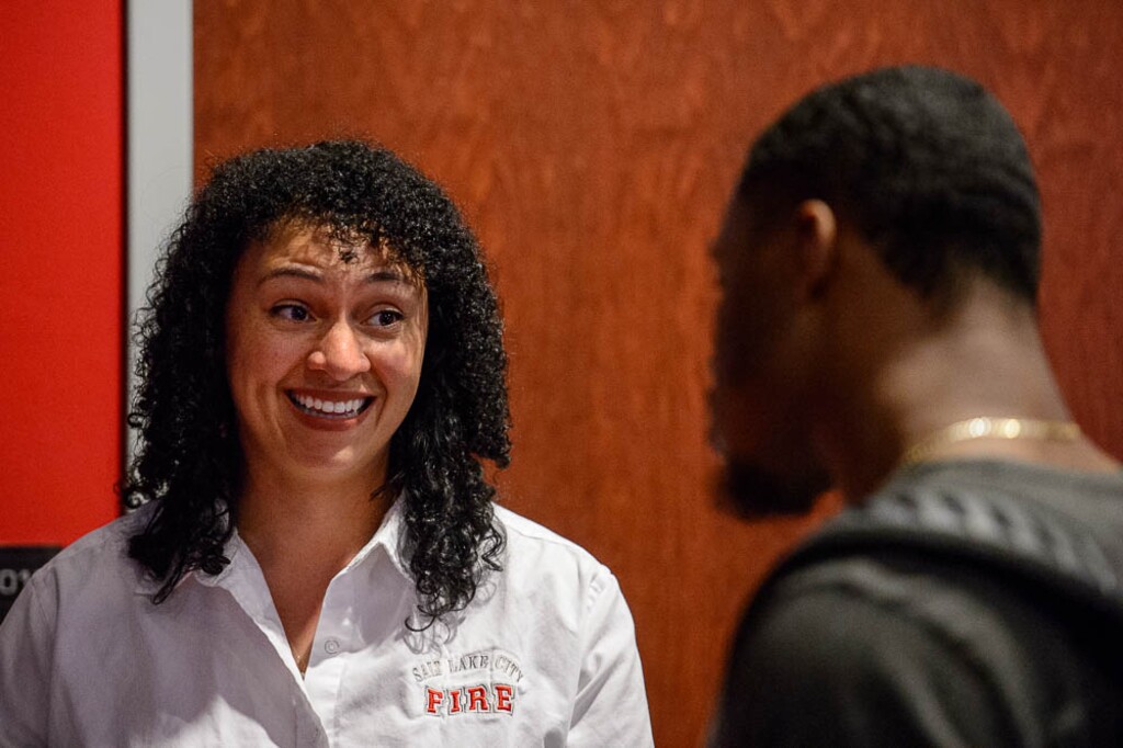 (Trent Nelson | The Salt Lake Tribune)  
Salt Lake City Fire Department's Darby Egbert gives information about the department to Donavan Thompson during a career networking event at the University of Utah, Wednesday, March 14, 2018.